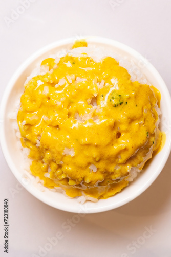 top view bowl of rice with curry on top at vertical composition