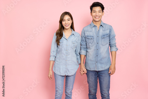 Portrait of young Asian couple smiling in jeans outfit isolated on pink background, Two people concept