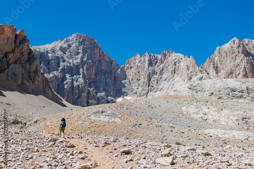 child travels in the mountains with a backpack. mountain hike in high mountains. Turkey. © zhukovvvlad
