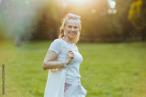 happy trendy woman in white shirt with tote bag