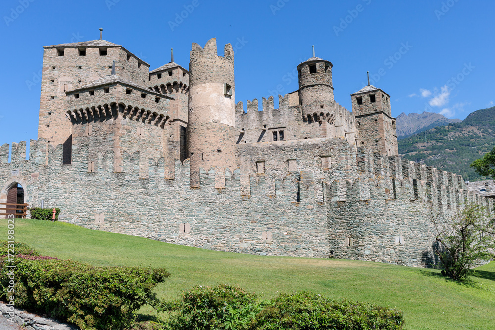 Italy Fenis Castle with mountains and blue sky in the background in summer