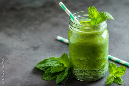 Green spinach smoothie. Green vegetable juice on rustic wood table. Blended green smoothie. Healthy breakfast with green smoothie in glass jar and ingredients. Detox, diet, healthy, vegetarian food co