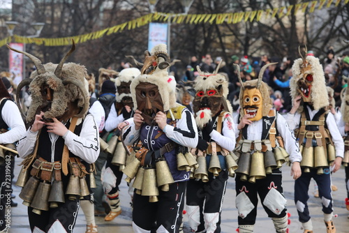 Pernik, Bulgaria - January 27, 2024: The 30th International masquerade festival Surva in Pernik, Bulgaria. People with mask called Kukeri dance and perform to scare the evil spirits. photo
