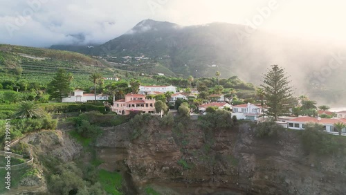 Aerial drone 4k footage of ocean waves crushing into the shore. Beautiful nature in Spain, Tenerife. Buildings and hotels on the seaside.