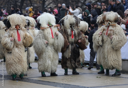 Pernik, Bulgaria - January 27, 2024: The 30th International masquerade festival Surva in Pernik, Bulgaria. People with mask called Kukeri dance and perform to scare the evil spirits. photo