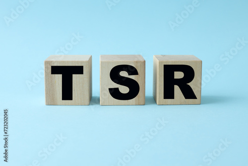 TSR Total Shareholder Return. blue background with cubes. text on wooden blocks