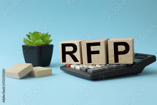 RFP Request For Proposal. text on wooden blocks. cubes on a calculator photo