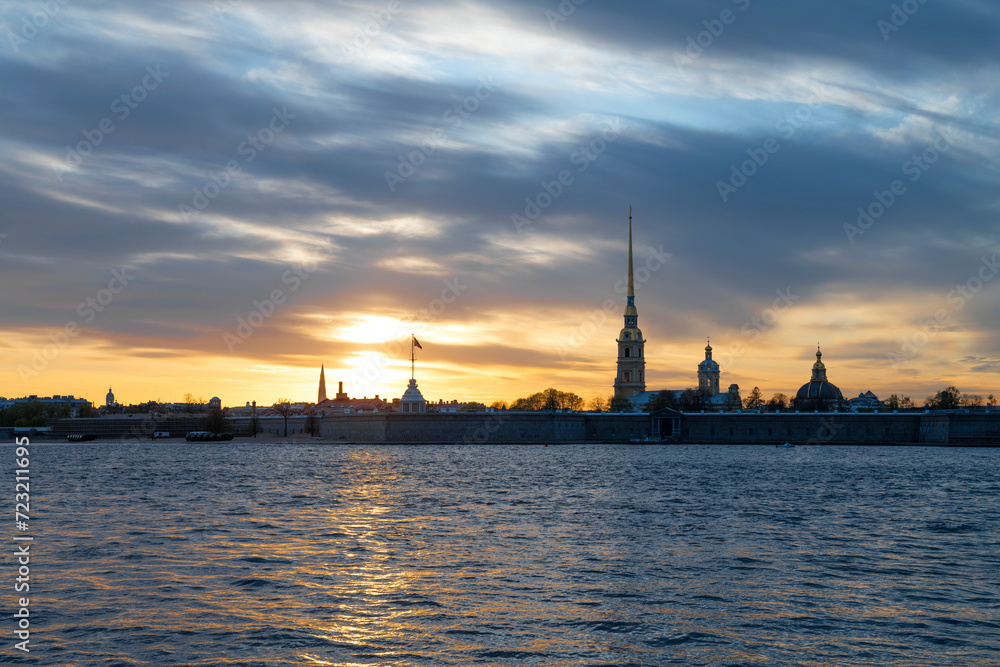 The ancient Peter and Paul fortress against the backdrop of a cloudy May sunset. Historic center of St. Petersburg, Russia