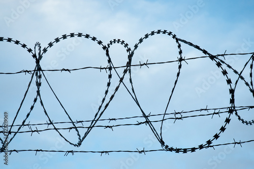 barbed wire Fidget-Alligator against a blue sky photo