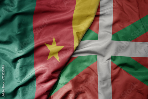 big waving national colorful flag of basque country and national flag of cameroon .