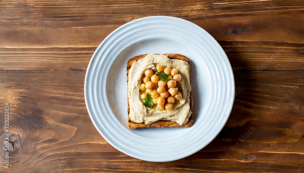 hummus toast on wooden background traditional eastern food with chickpeas tahini and olive oil toast on wooden background top view