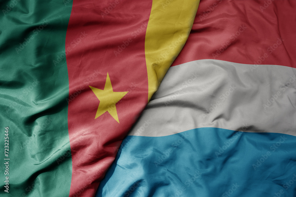big waving national colorful flag of luxembourg and national flag of cameroon .