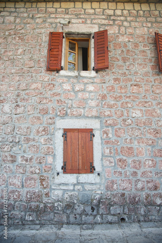 Windows with shutters on an old stone wall, Montenegro.