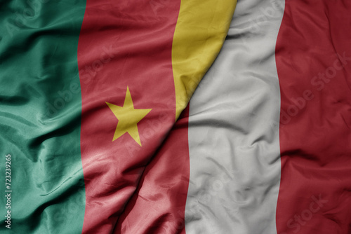 big waving national colorful flag of peru and national flag of cameroon .