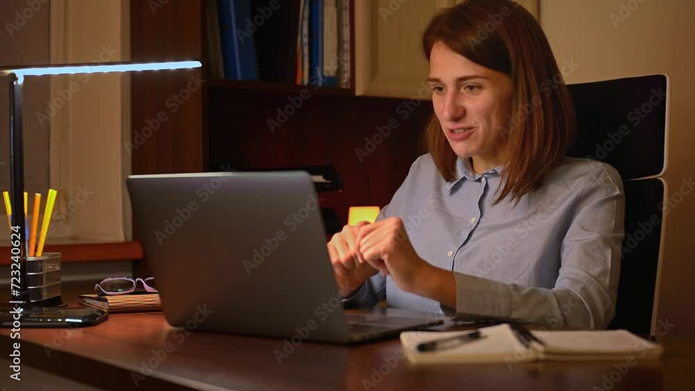 A young woman, immersed in a video call, expresses her excitement and enthusiasm through positive emotions and expressive gestures. This video beautifully captures the essence of remote work. A young woman, immersed in a video call, expresses her excitement and enthusiasm through positive emotions and expressive gestures. This video beautifully captures the essence of remote work.