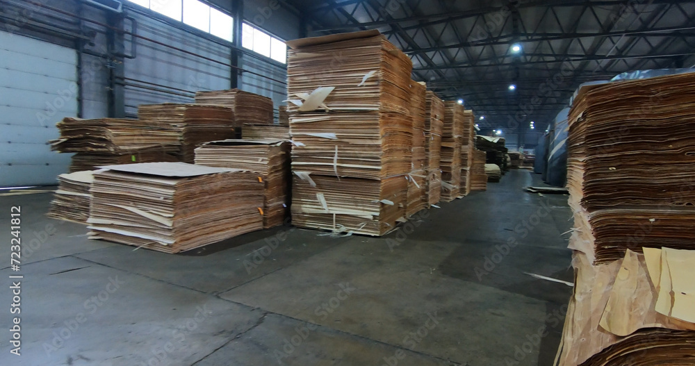 Sheets of plywood slabs are stacked in the warehouse of the woodworking plant Sheets of plywood slabs are stacked in the warehouse of the woodworking plant
