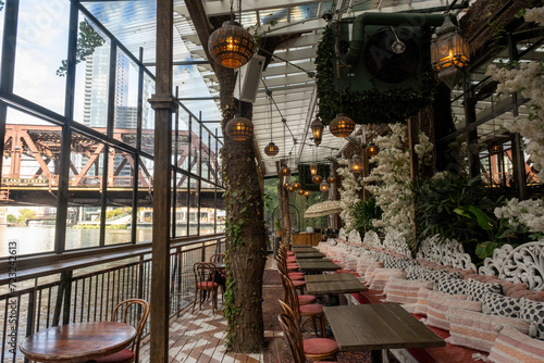 Romantic cozy restaurant on the river with pretty lights and tables
