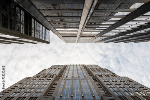 Two skyscrapers almost touching each other above the sky