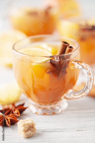 Homemade Wassail Mulled Apple Cider with Lemon and Spices in glasses. Winter alcoholic hot drink.