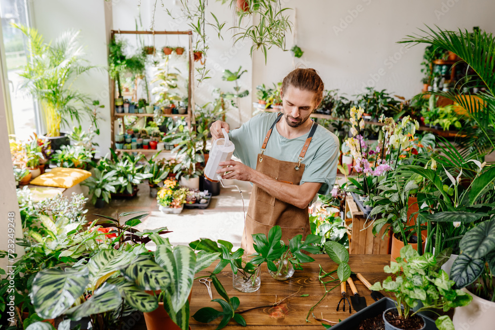 man pour water watercan shop plant man pour water watercan shop plant