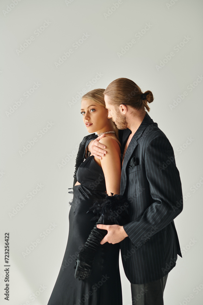 bearded good looking man in black suit hugging sensually his young beautiful girlfriend, couple bearded good looking man in black suit hugging sensually his young beautiful girlfriend, couple