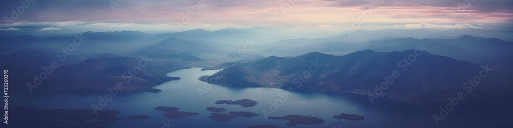 an aerial photo from an airplane of a lake mountains