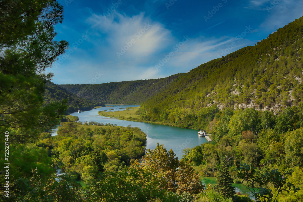 Krka Majesty: A Breathtaking Aerial Vista of the River, Trees, Hills, and Blue Sky