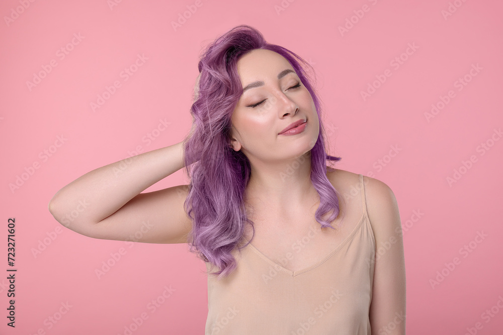 Trendy hairstyle. Young woman with colorful dyed hair on pink background Trendy hairstyle. Young woman with colorful dyed hair on pink background