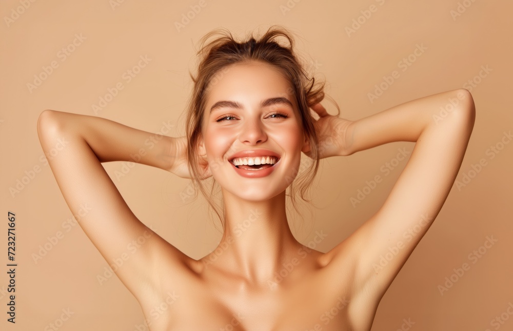A beautiful young smiling girl on a coloured background has her hands up in the air and is laughing A beautiful young smiling girl on a coloured background has her hands up in the air and is laughing