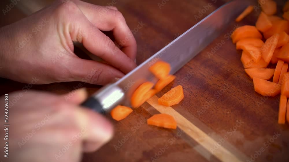 Cutting carrots into slices with a vegetables knife Cutting carrots into slices with a vegetables knife