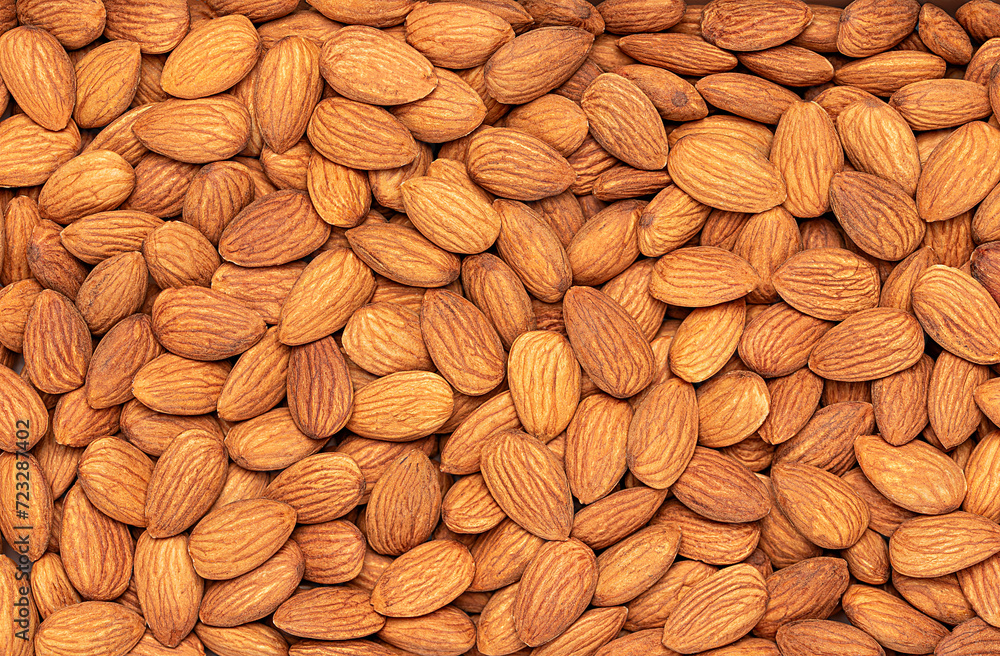 Macro blank photography of raw whole almonds, nuts, seeds, kernel, many, tasty, fresh; pattern; background; textured Macro blank photography of raw whole almonds, nuts, seeds, kernel, many, tasty, fresh; pattern; background; textured