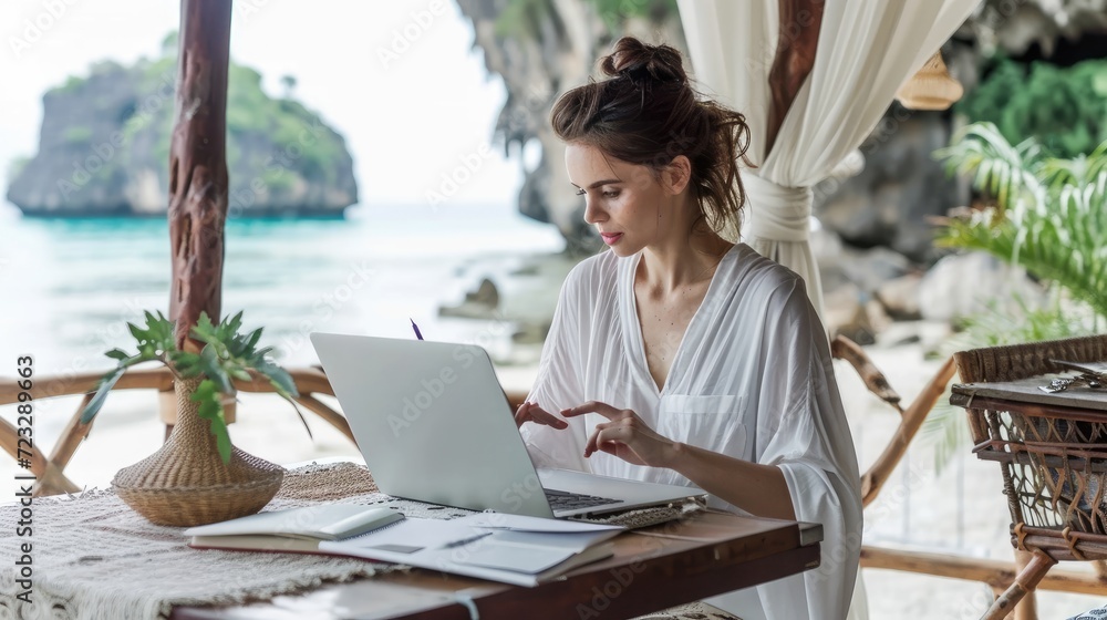 Woman Working on Laptop in Tropical Setting