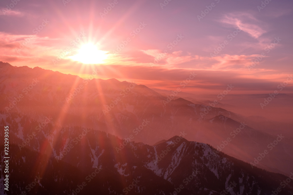 Magical atmosphere of a sunset in the highlands; wonderful view of numerous mountain ridges at sunset Magical atmosphere of a sunset in the highlands; wonderful view of numerous mountain ridges at sunset