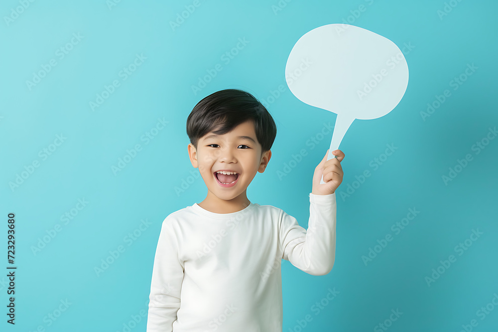 Portrait of cute Asian boy holding up empty speech bubble for text in studio background. Portrait of cute Asian boy holding up empty speech bubble for text in studio background.