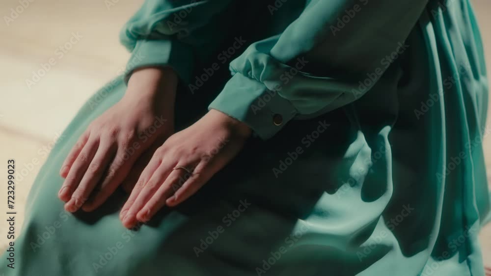Woman's Hands on Legs During Sitting in Islamic Prayer, Modest Green Dress Woman's Hands on Legs During Sitting in Islamic Prayer, Modest Green Dress