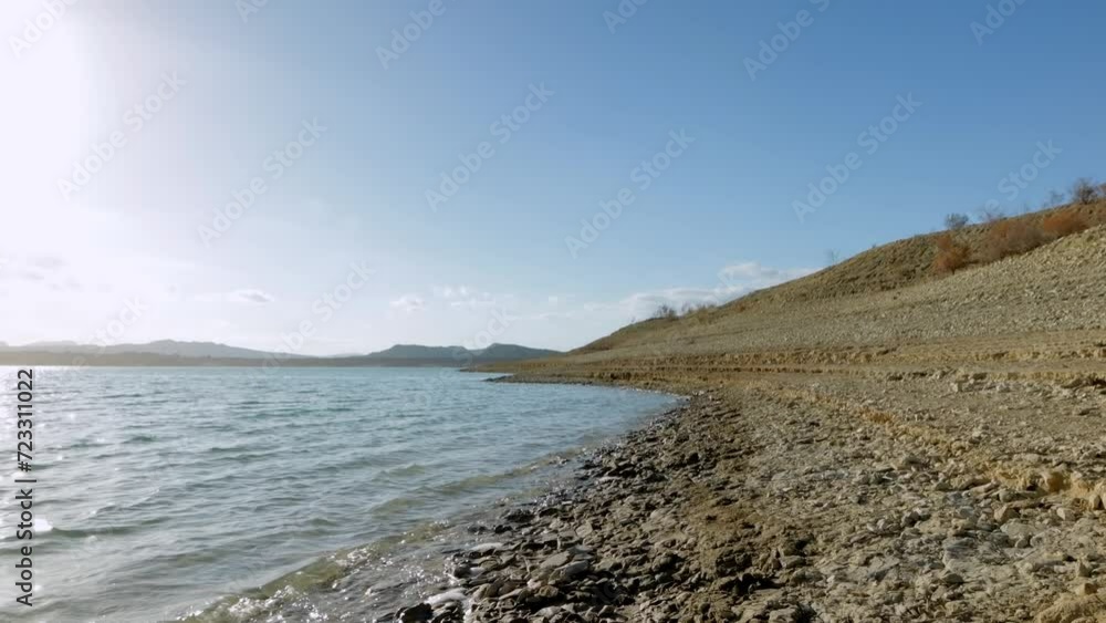 Waves in sea on sunrise. Pebble stone beach on sunset. Sea beach shore with waves in ocean. Waves in sea on sunrise. Pebble stone beach on sunset. Sea beach shore with waves in ocean.