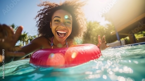 Ecstatic young lady holding swimming circle