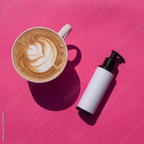 Cosmetic pump bottle mockup with latte on pink background