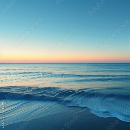  a view of the ocean at sunset with a wave in the foreground and an orange and blue sky in the background with the sun reflecting off of the water. © Jevjenijs