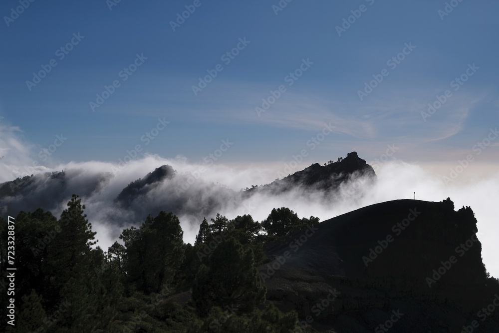 Beautiful mountain scenery of National Park Caldera de Taburiente with clouds lit by sun during inversion. La Palma, Canary Islands, Spain Beautiful mountain scenery of National Park Caldera de Taburiente with clouds lit by sun during inversion. La Palma, Canary Islands, Spain