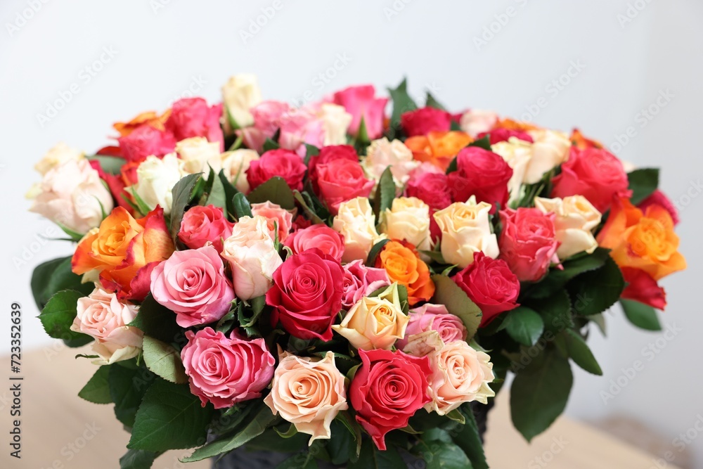 Bouquet of beautiful roses on light background