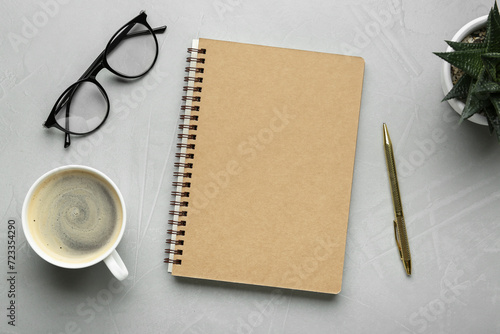 Flat lay composition with notebook on light textured table