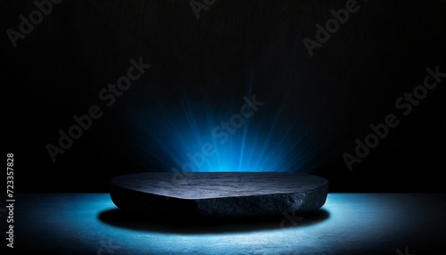 black stone platform podium with blue color light on black background for product display presentation and advertising copy space