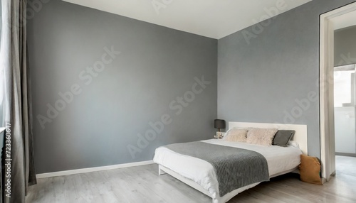 cozy bedroom corner in minimal modern style with empty cool gray painted wall in the background in terior concept background for advertising photo