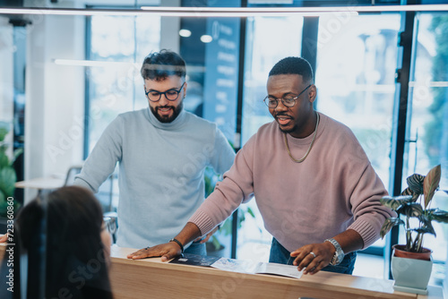 Two businessmen in business attire discussing a real estate agreement. One is a realtor and the other is a potential buyer. They are negotiating prices and signing the contract.