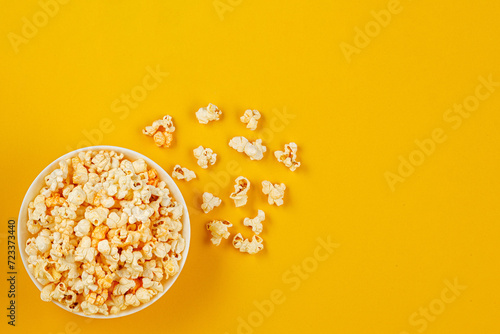 plate with popcorn on a yellow background