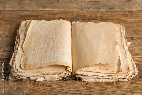 Open old book on wooden bac...