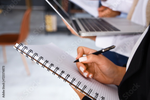 Businesswoman with notebook...