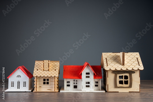 Photography Wooden houses on gray background, home buying and selling concept