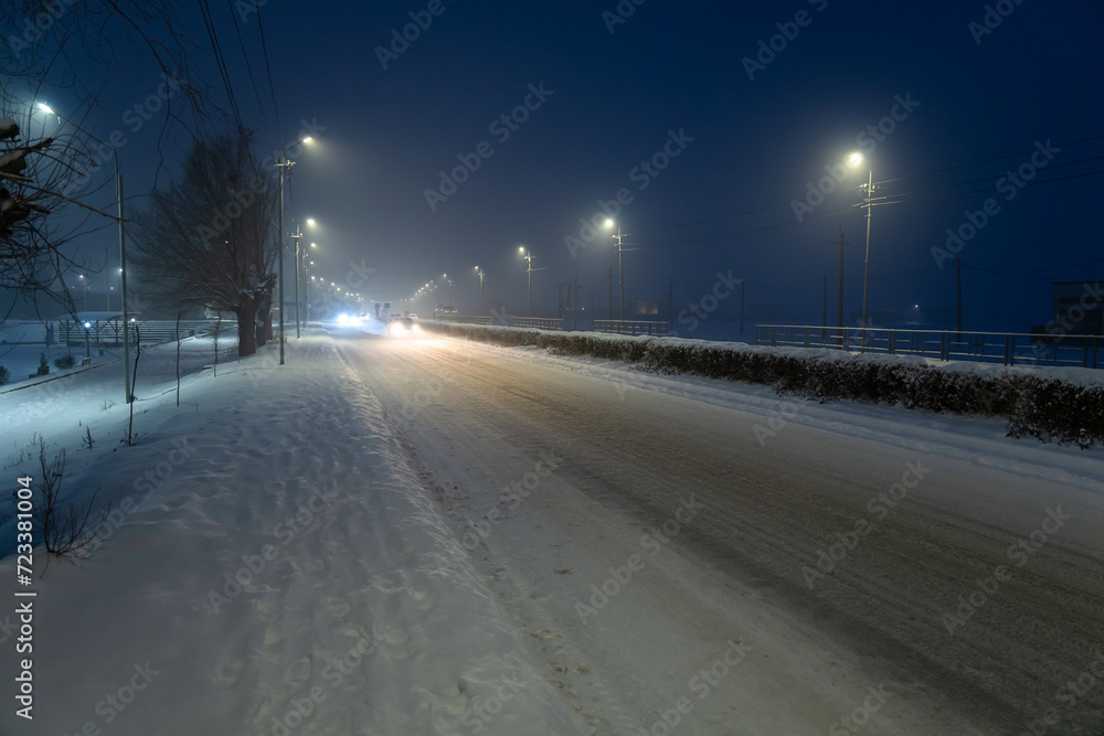  A Nighttime Journey Along a Serene Snow-Covered Road